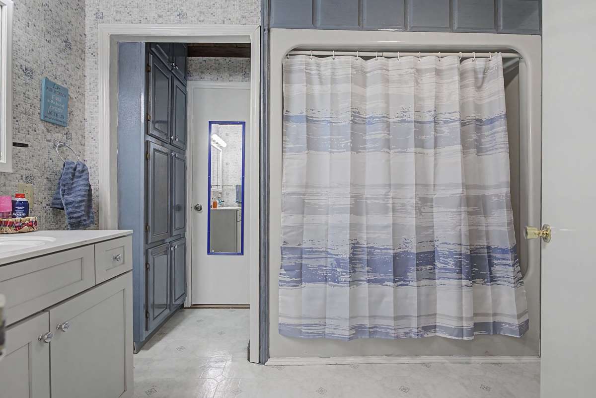 Hall bathroom with shower, tub and vanity