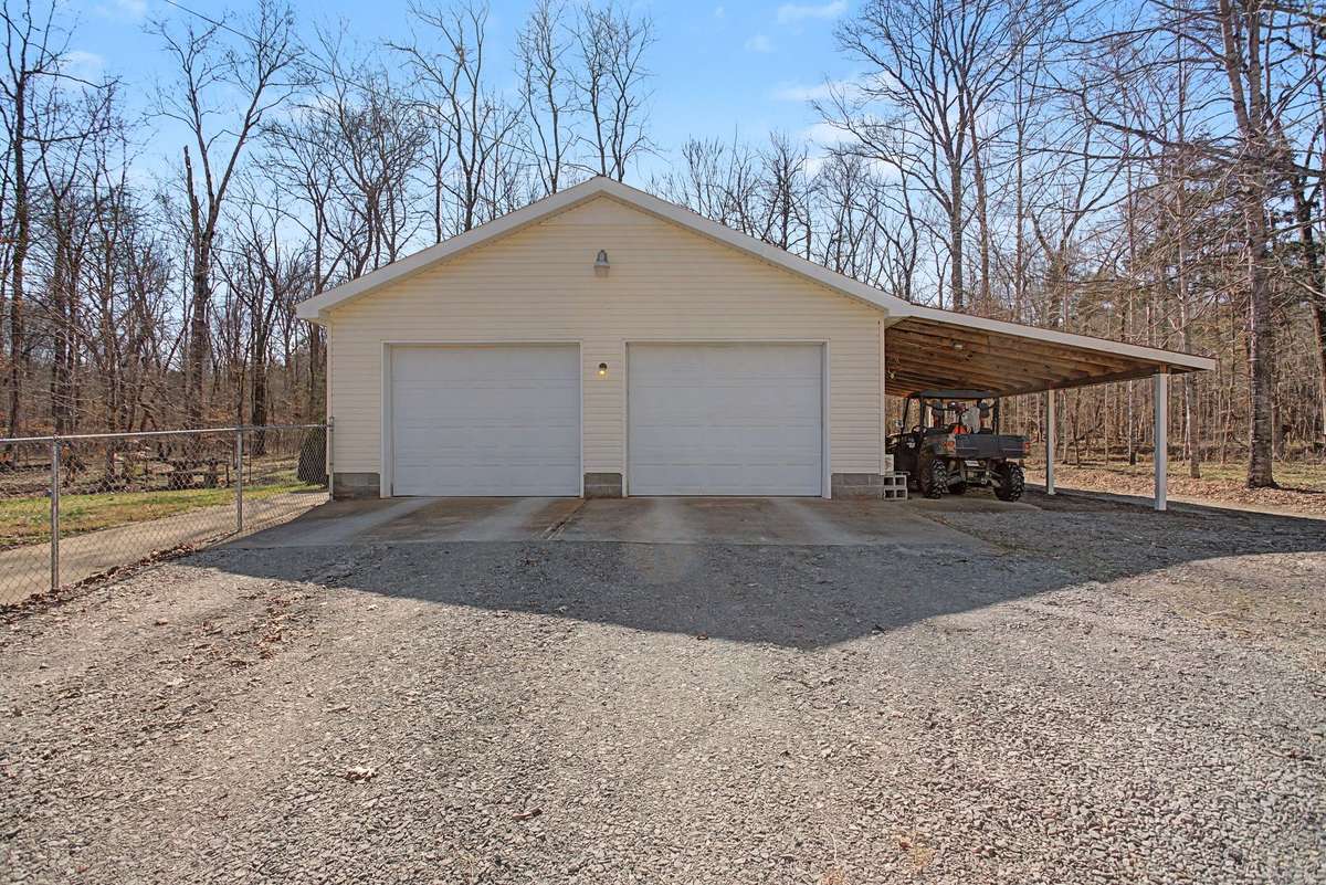 Two Car detached garage with garage door openers and covered carport