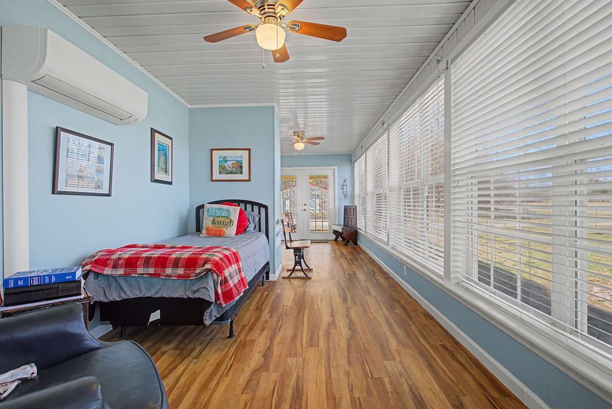 Another view of the sunroom, currently being used as an extra bunk room and office