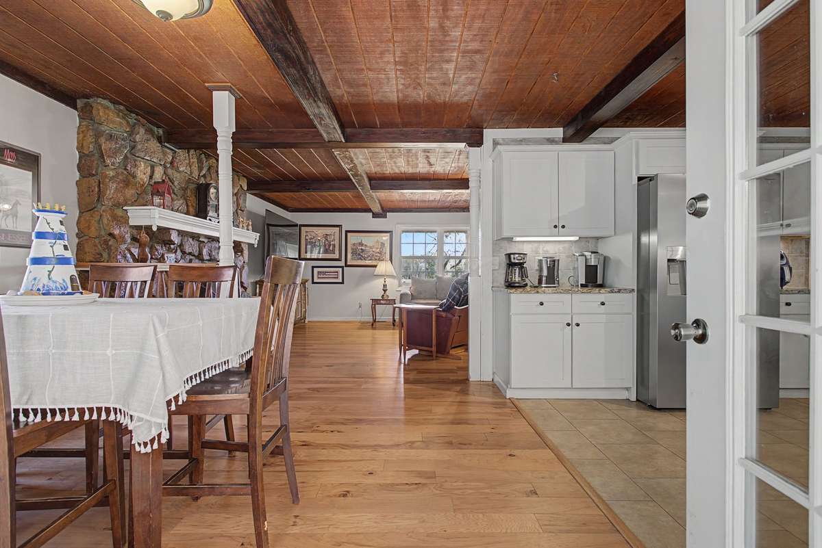 A view of the eat in area, kitchen and family room from the back door entrance