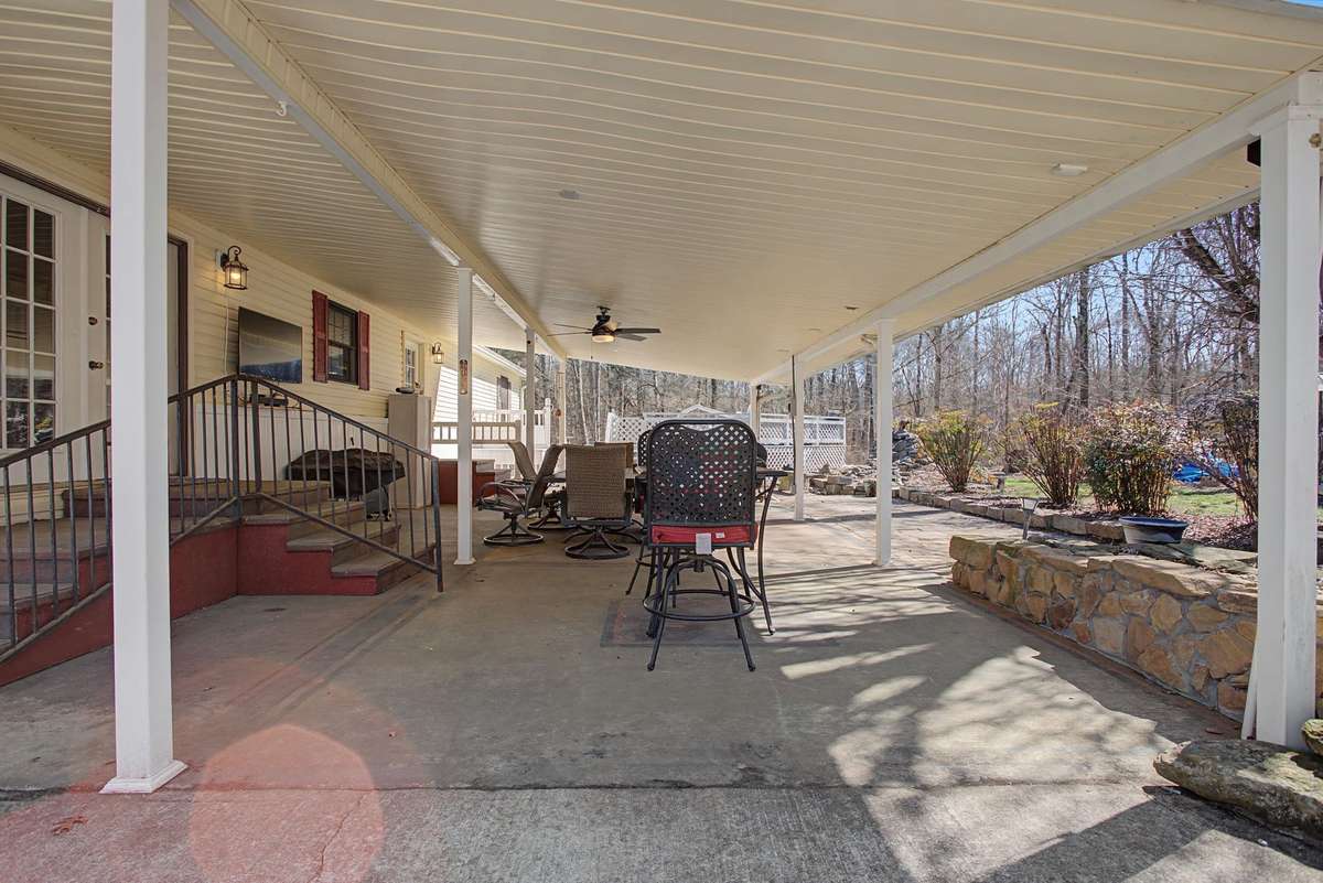 Large covered patio overlooking backyard perfect for entertaining family and friends