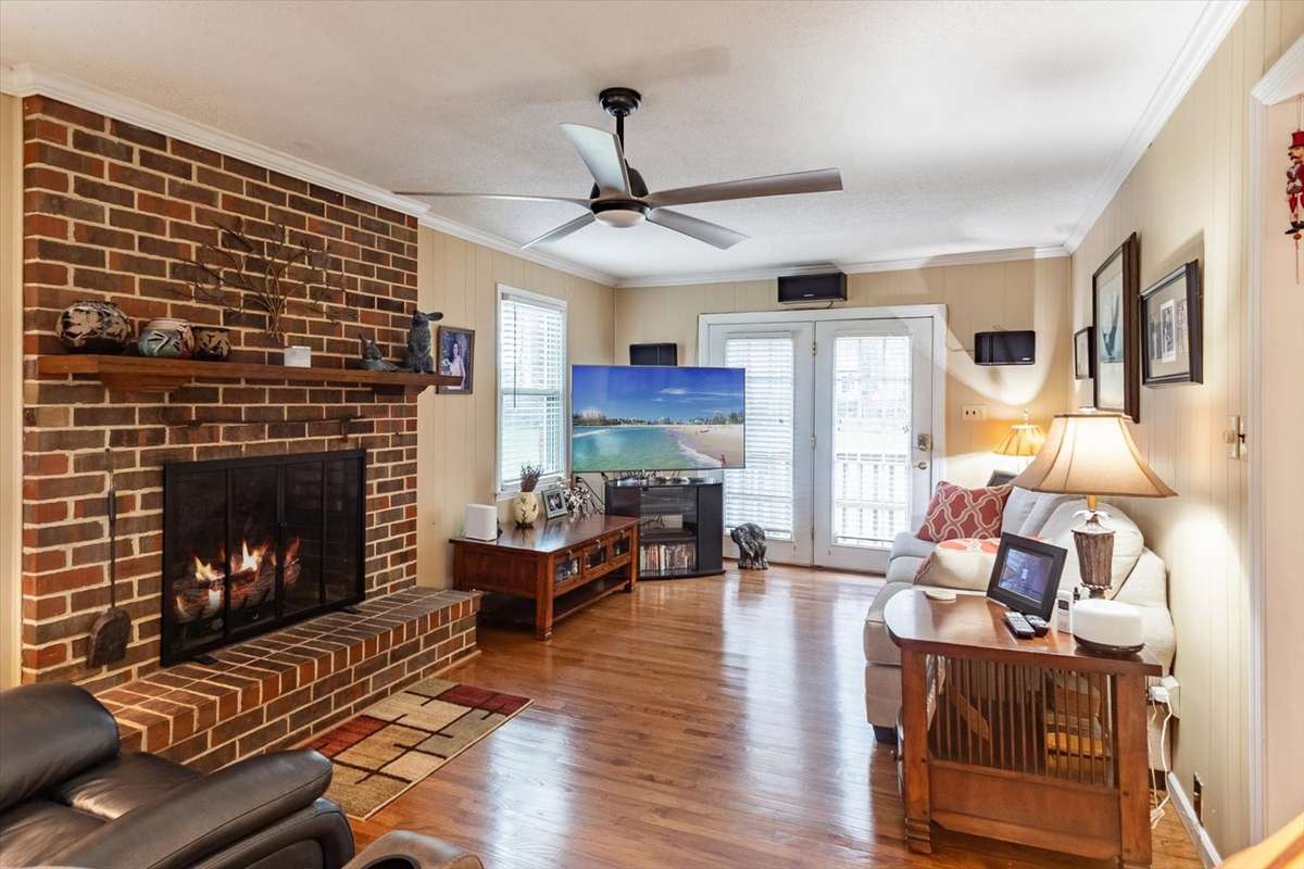 A GORGEOUS LIVING/FAMILY ROOM WITH A FIREPLACE & GORGEOUS WOOD FLOORS