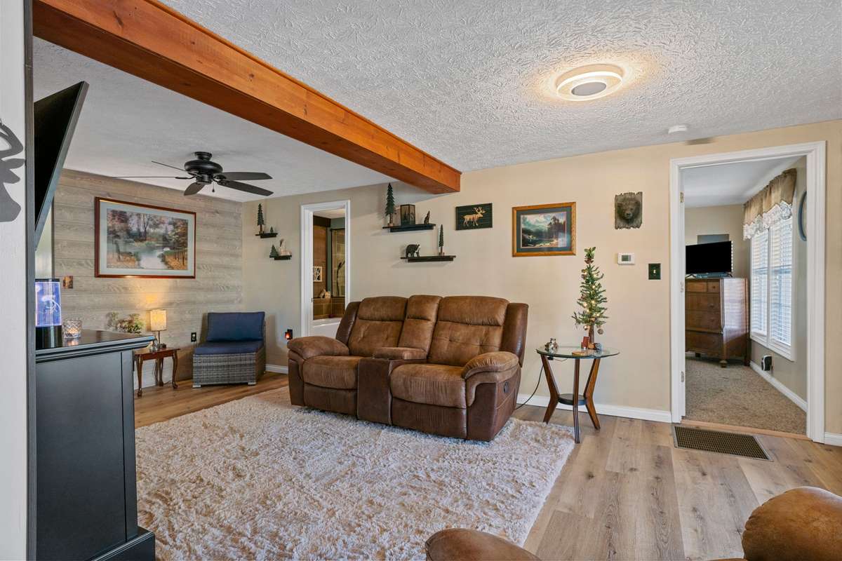 Living Room w/new laminate & view to full bath & lake side front bedroom #1.