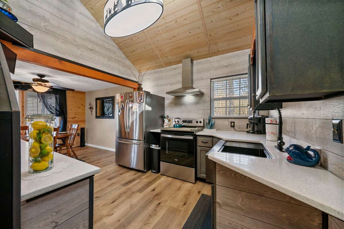 Updated kitchen w/high ceilings, natural light, quartz countertops, new appliances, farmhouse sink.