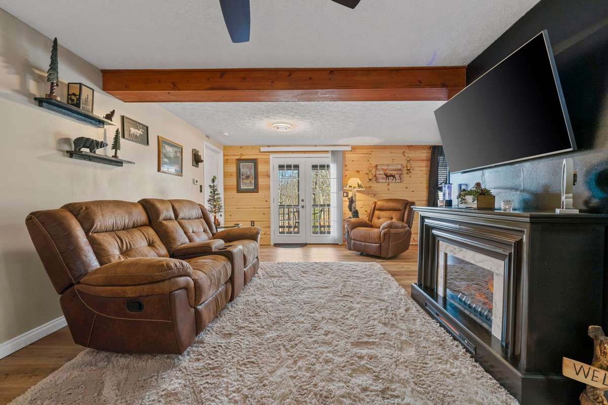 TV, Electric fireplace, 2 seat reclining sofa w/center charging console & drink holders to remain.