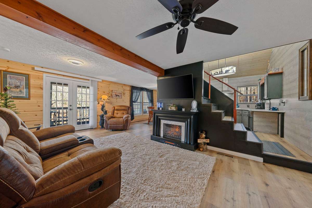 Living Room w/electric fireplace, dining room & kitchen views.