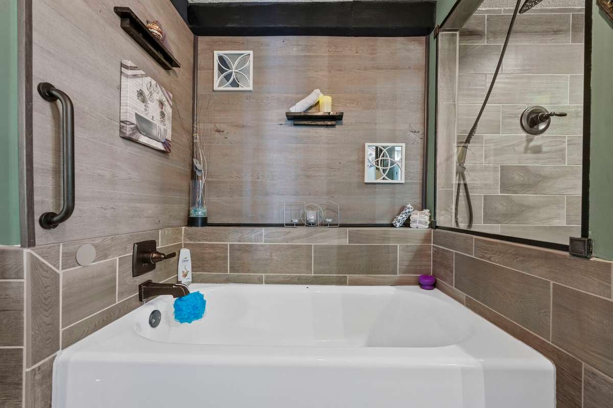 Main floor bath with separate tub & tiled walk-in shower.