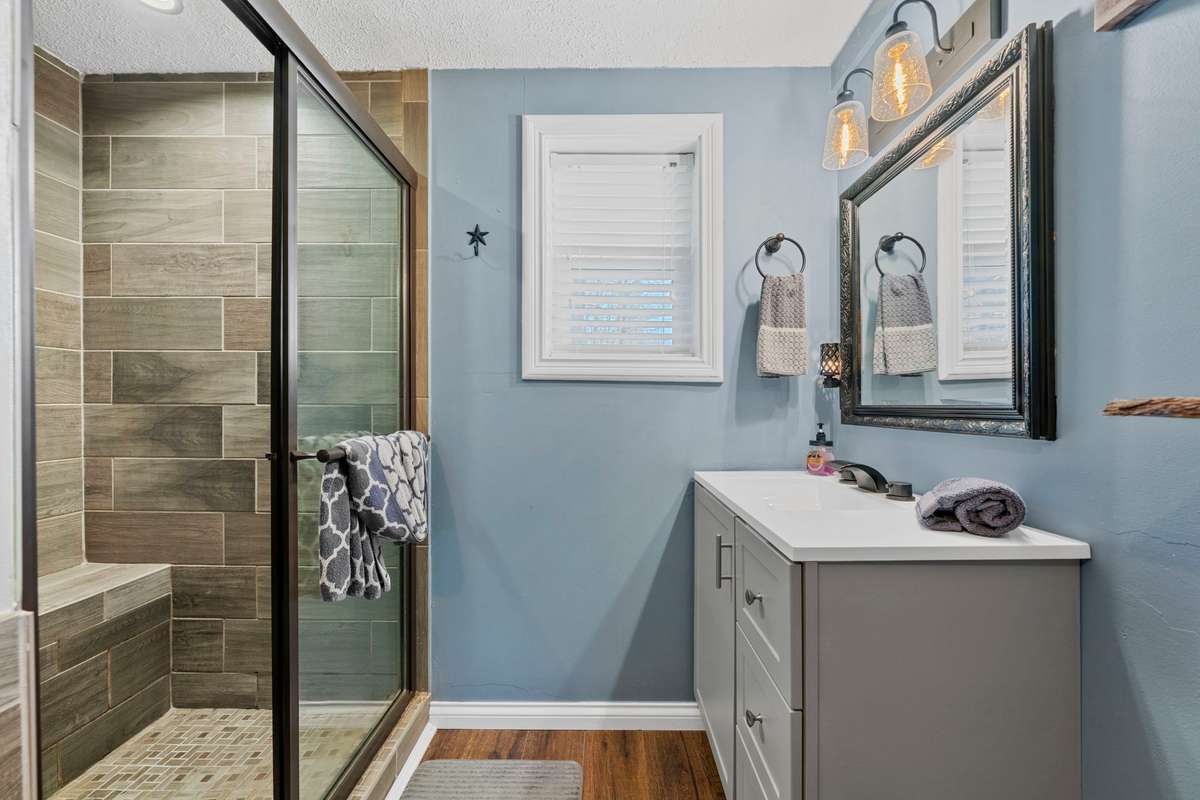 Main floor bath with separate tub & tiled walk-in shower.