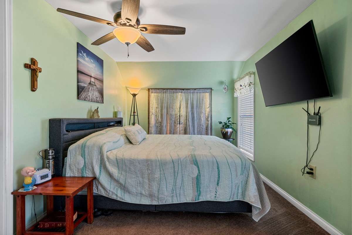Upstairs Bedroom #3: Big screen TV, King size bed w/headboard, frame & dresser to remain.