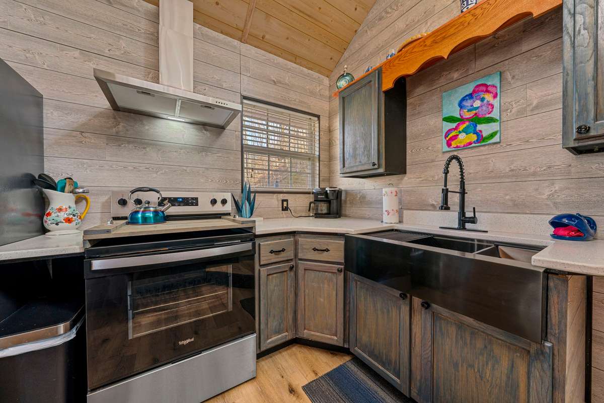 Renovated kitchen with new appliances, farmhouse sink, natural light and high ceilings.