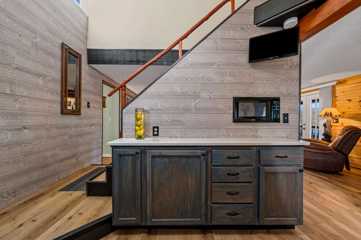 Kitchen coffee bar, tv & microwave, plus storage pantry under stairwell.