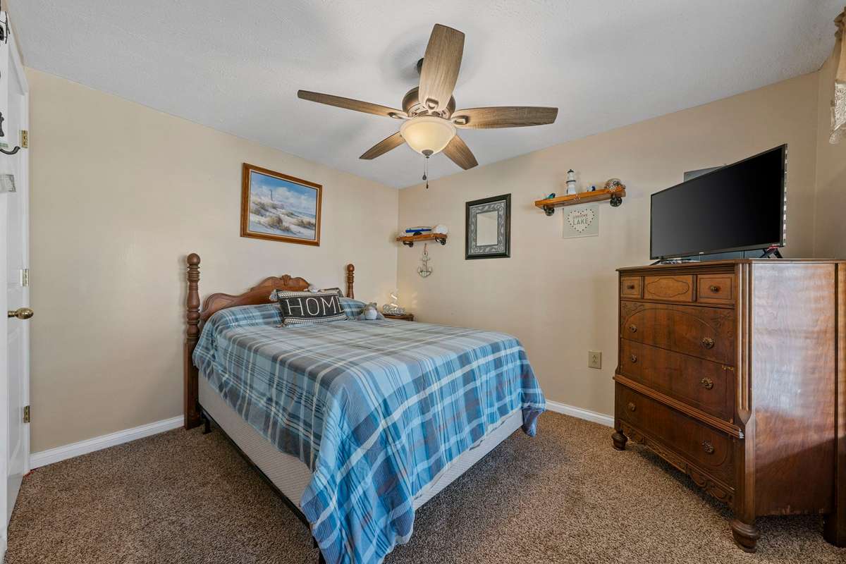 Main floor lakeside bedroom #1. Full size bed & dresser to remain.