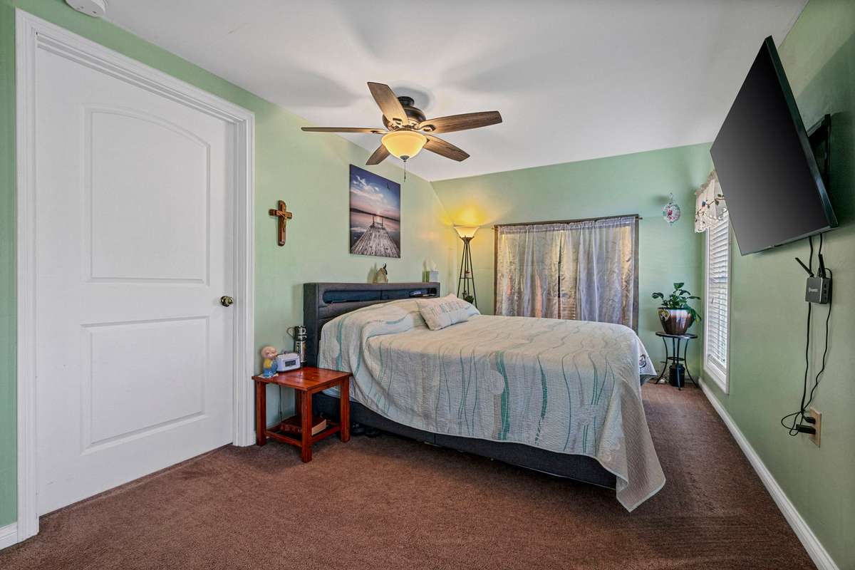 Upstairs Bedroom #3: Big screen TV, King size bed w/headboard, frame & dresser to remain.