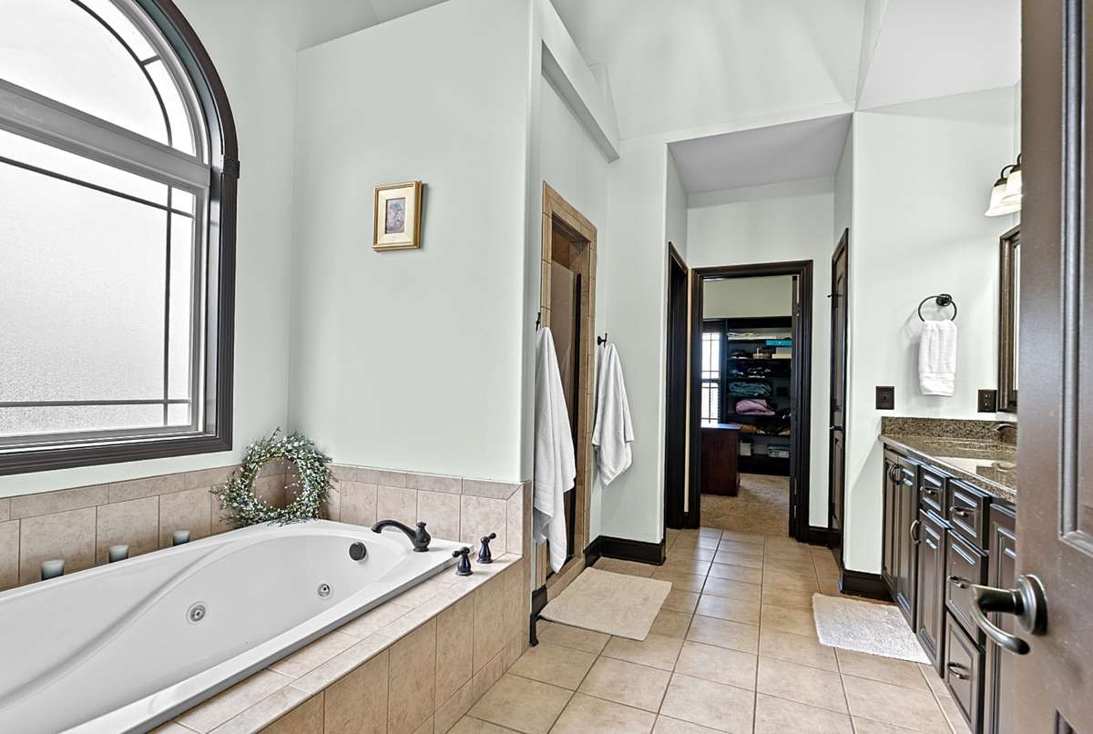 Primary Bath w/ tiled shower and spa tub