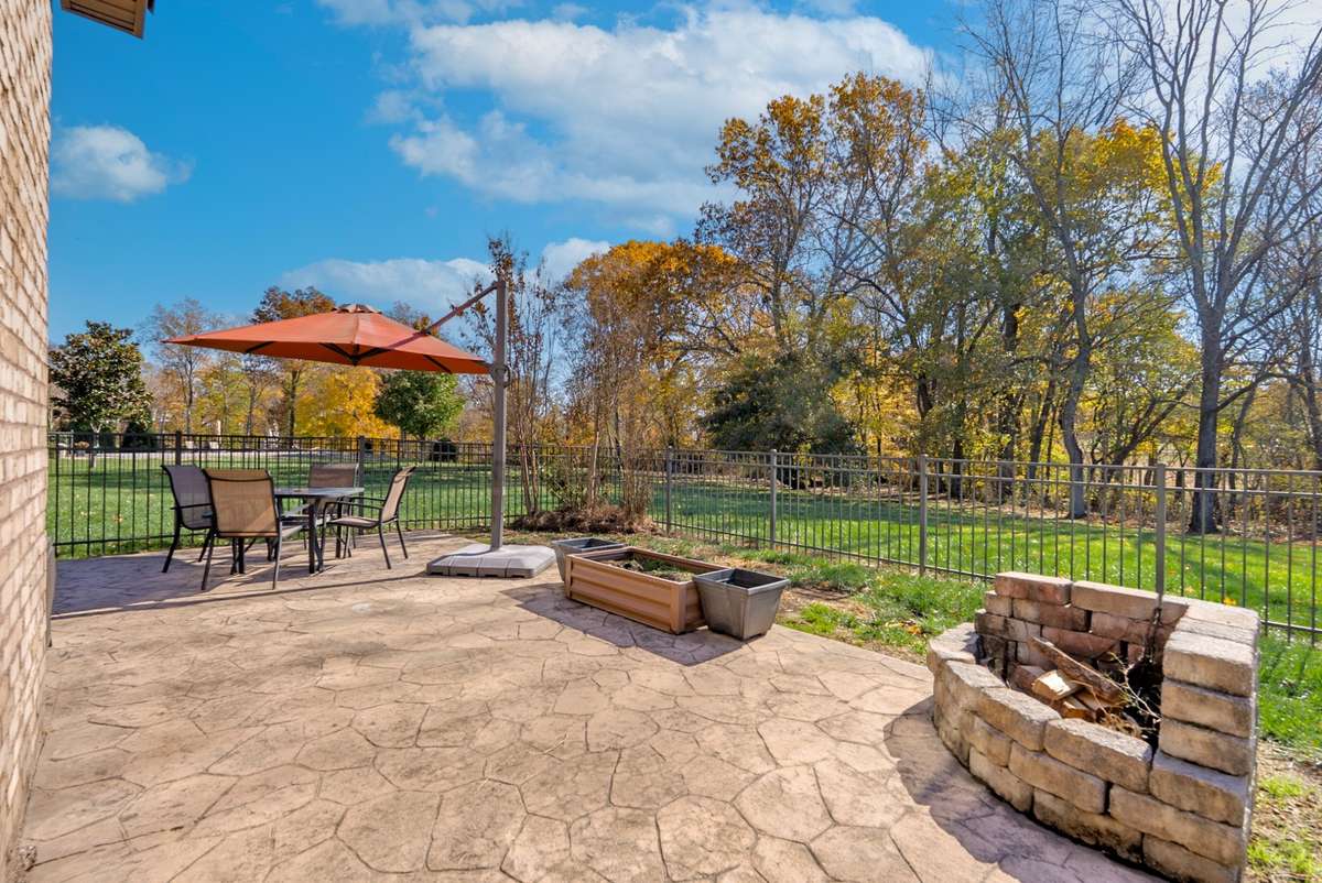 Stamped concrete patio with fire pit area.