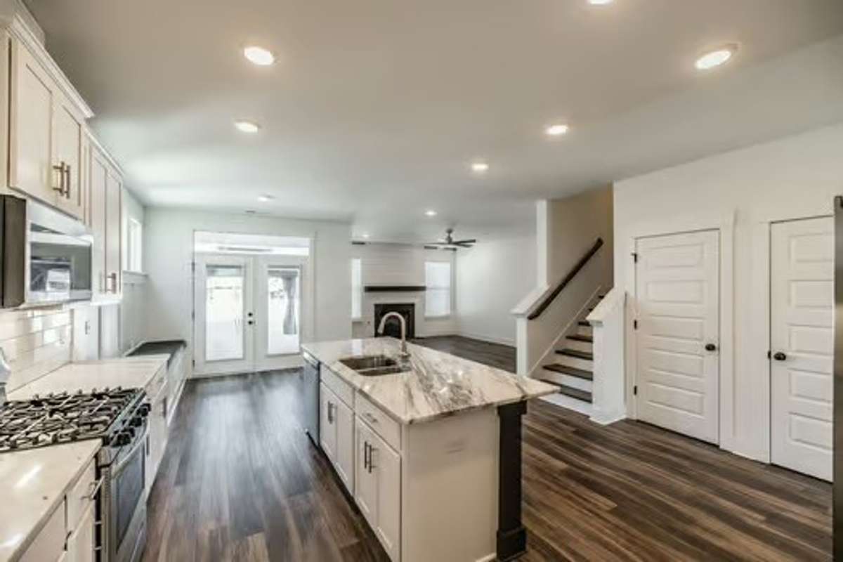 Open kitchen with large granite island, built in bench seating breakfast nook, living room with fireplace and all appliances included.