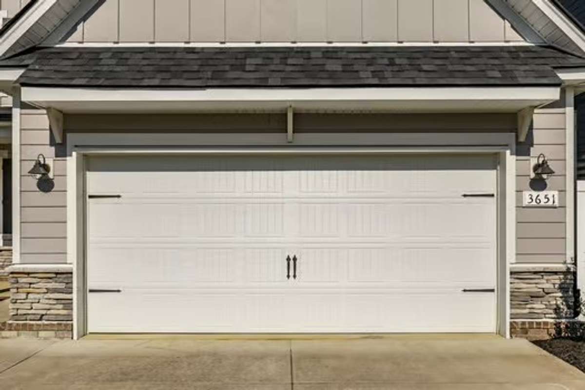 Two car garage with a long driveway for additional parking