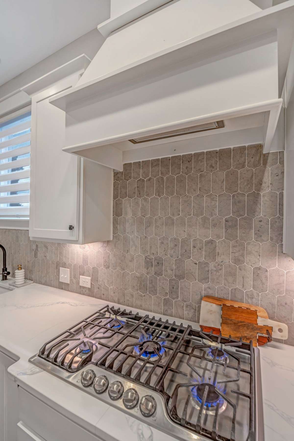 Built in Gas stove, Tile backsplash that gives nice appeal to the  kitchen