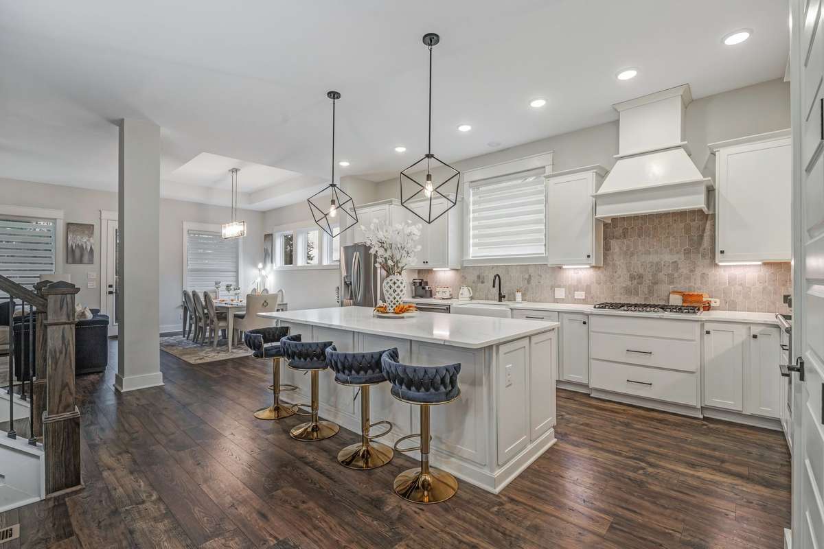 Quartz countertop with extended Island, Out vent hood, upgraded light fixtures