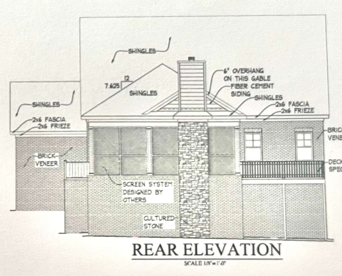 Back sloped lot . Notice the large Screened in back porch with wood burning fireplace and deck off of porch.