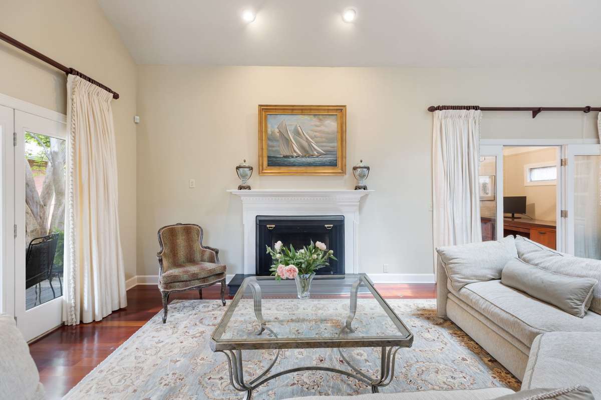 Inviting living room with gas fireplace and french doors open to covered patio