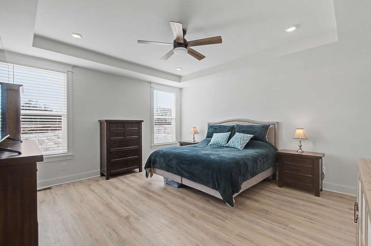 Primary bedroom on the main level features a trey ceiling and is so spacious!
