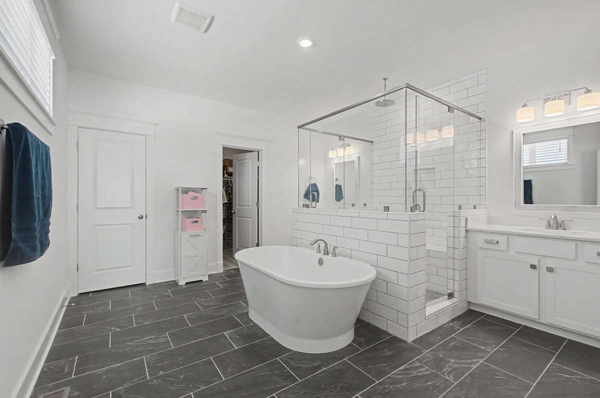 Primary bath with large shower, separate vanities, and freestanding tub! Relaxation plus!