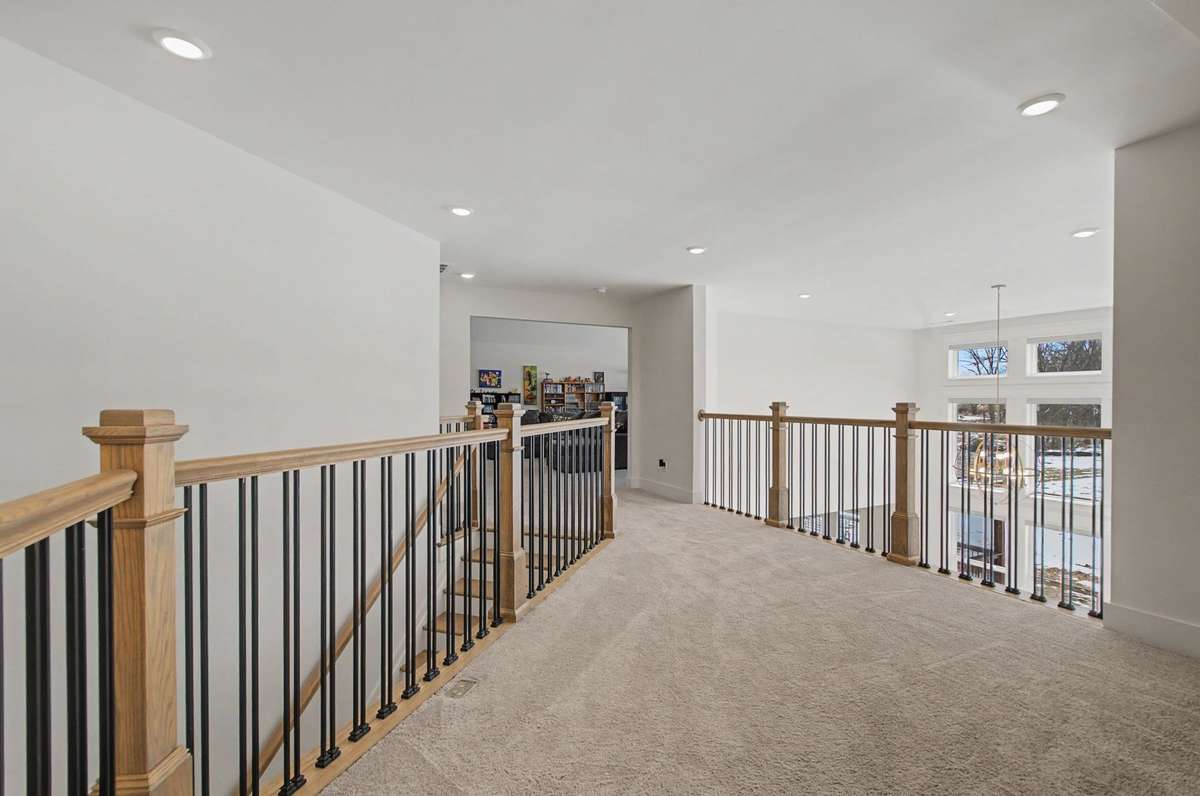 Landing on 2nd floor leading to 3 large bedrooms, 2 full baths and game/tv room with vaulted ceiling & finished out storage