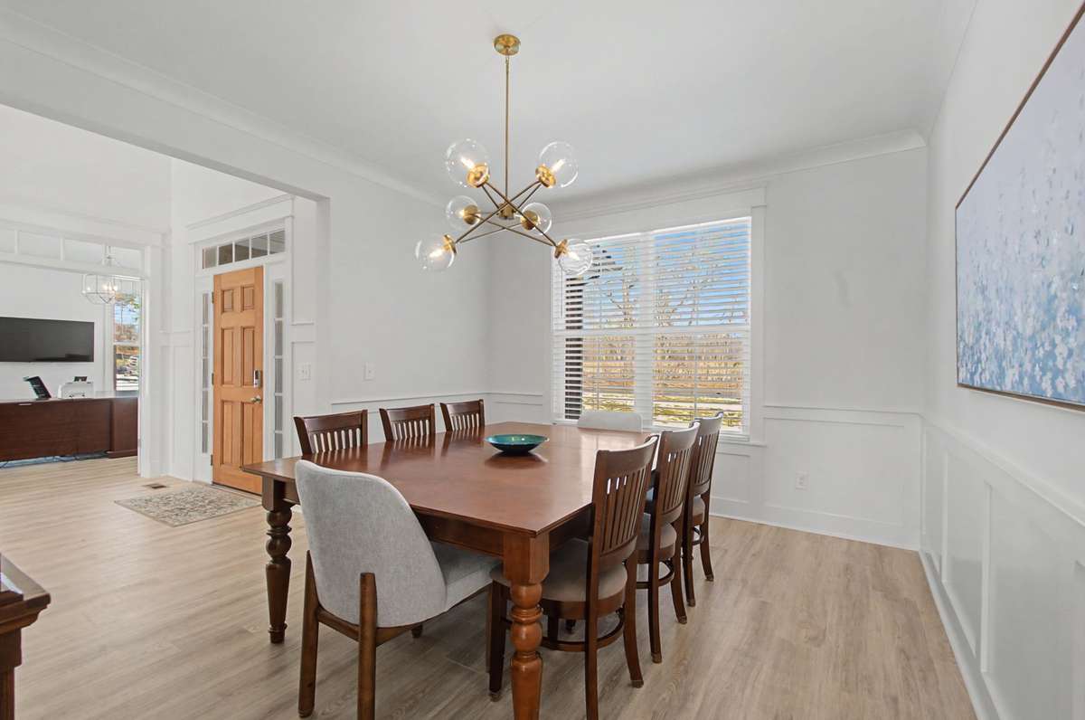 Tons of natural light in this home! Formal dining room-Love the light fixture & wainscoting!