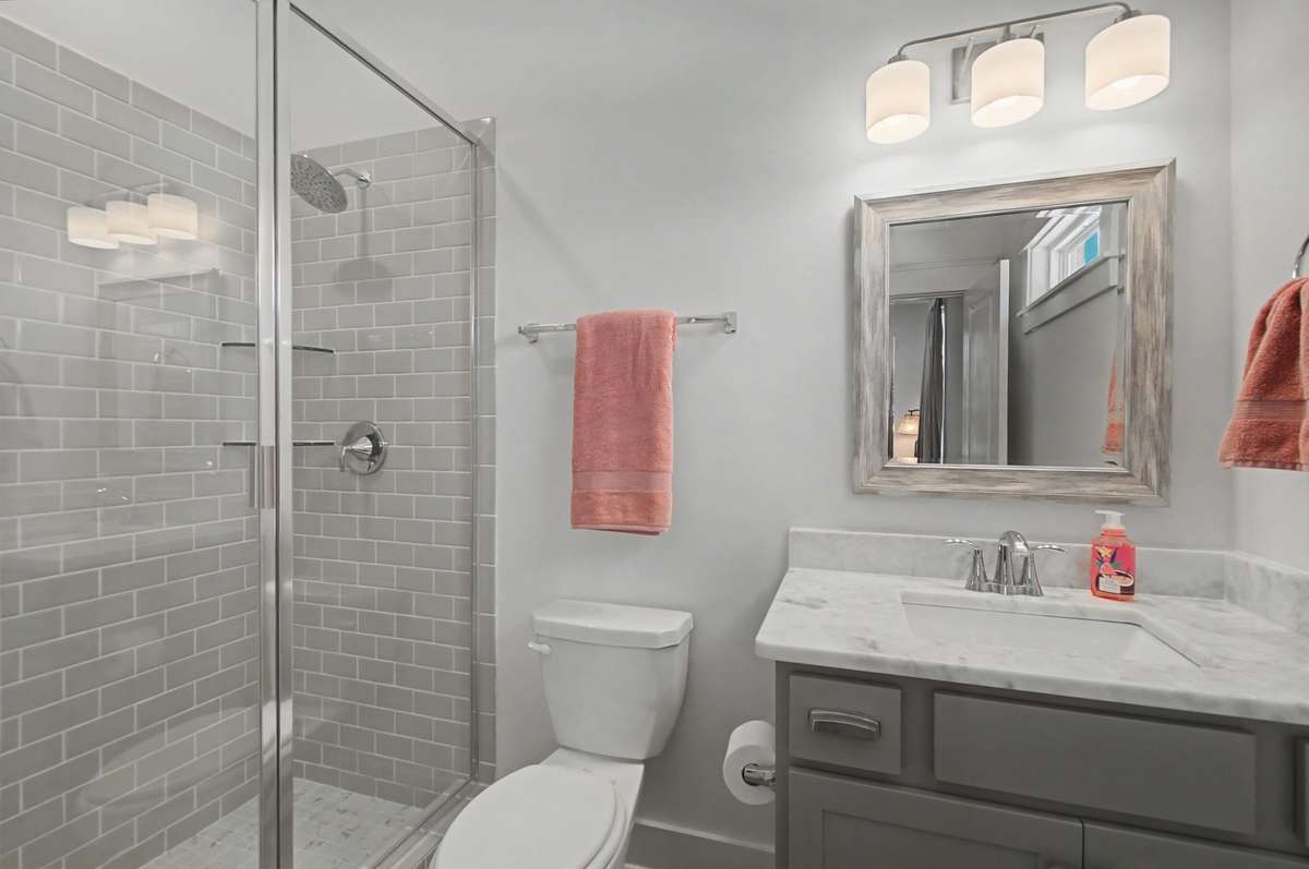 Full bathroom inside main floor secondary bedroom