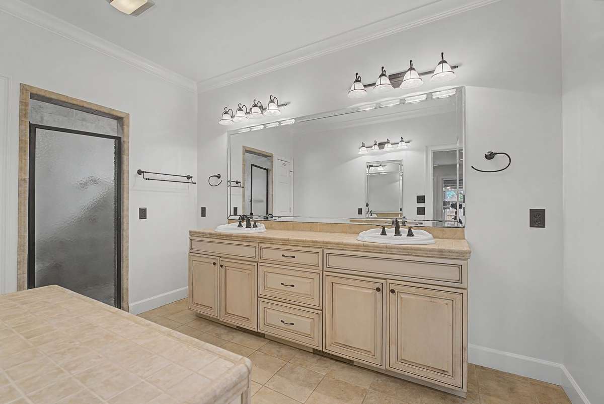 Dual vanities and a tile, walk-in shower.