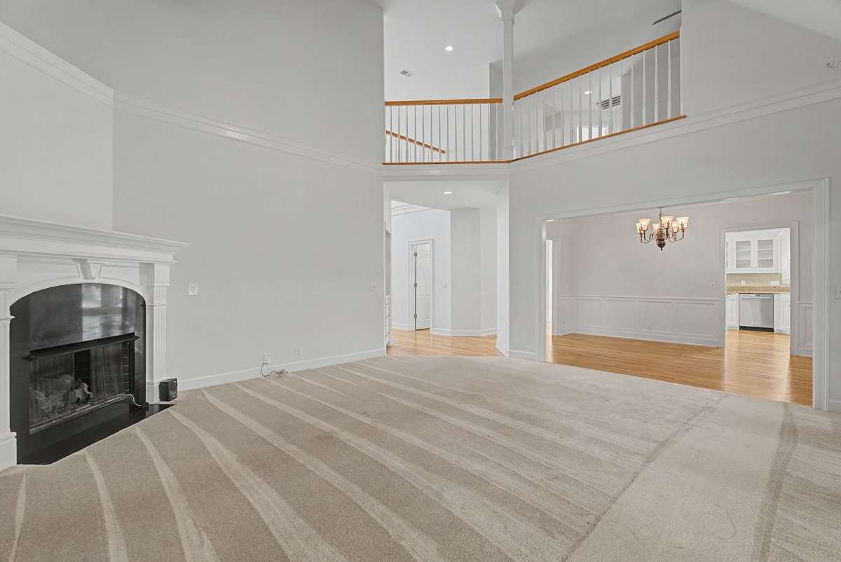 From the great room looking back towards the entry, you can see the extensive trim, loft, and formal dining room.
