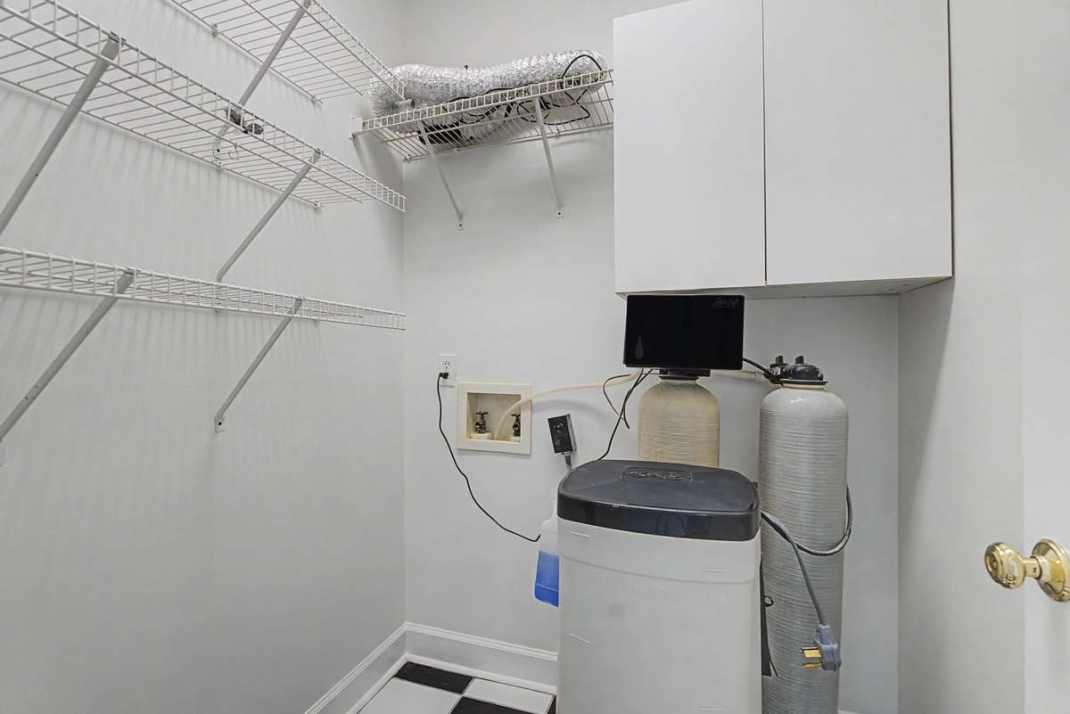 The original laundry room was off just off of the kitchen.  It was used for storage and currently houses a water softening system.  It could easily be converted back into a second laundry room or an additional, walk-in pantry!