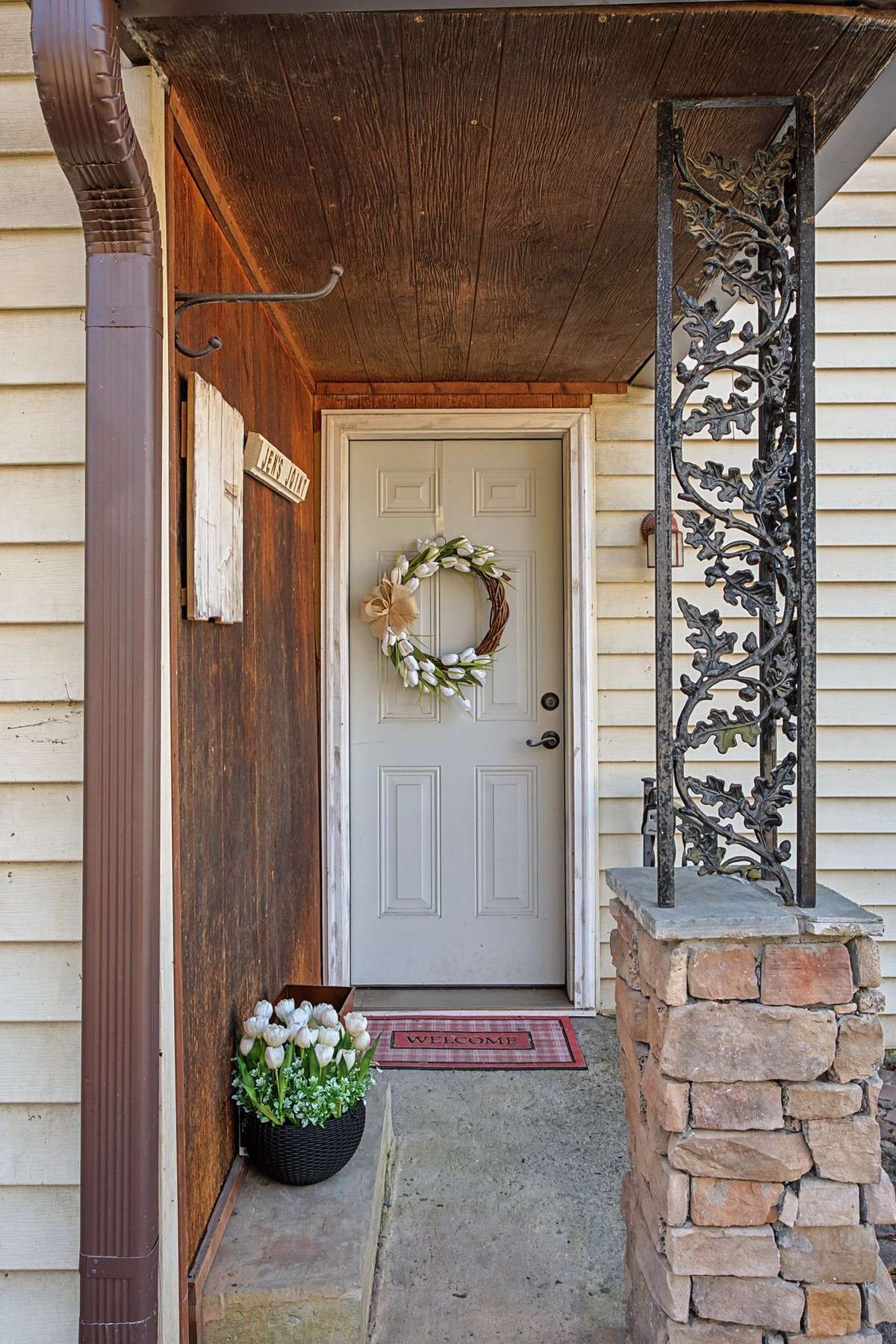 Pretty back door and a small porch for morning coffee before you are camera ready