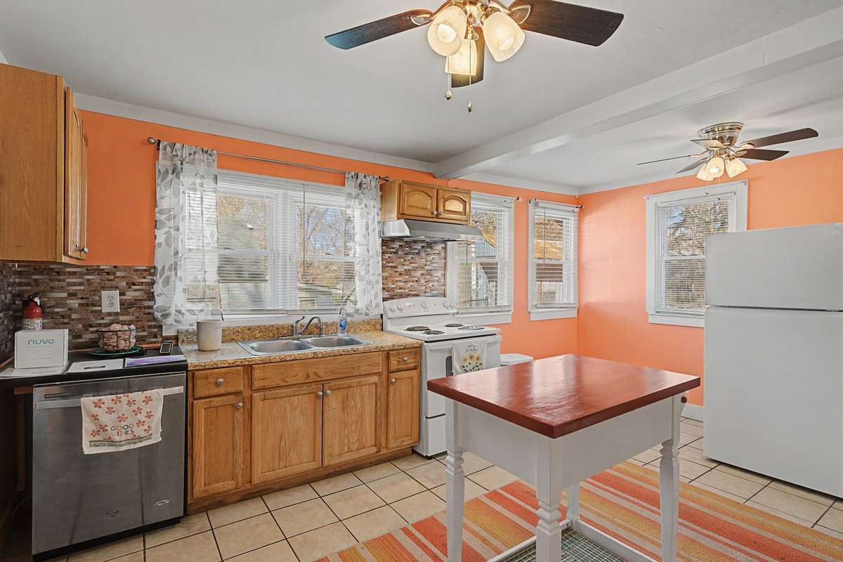 Fridge can slide into the empty corner or more cabinets can be added on that side
