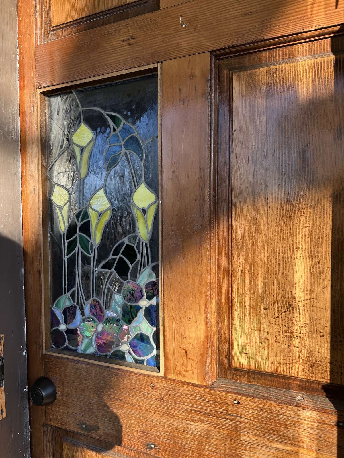 Full wood and pretty front door with stained glass element