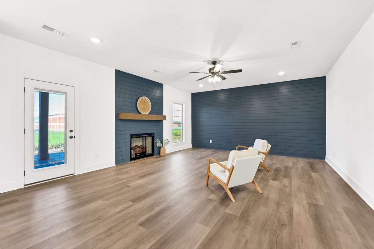 Beautiful gas fireplace and accent walls with access to the covered patio