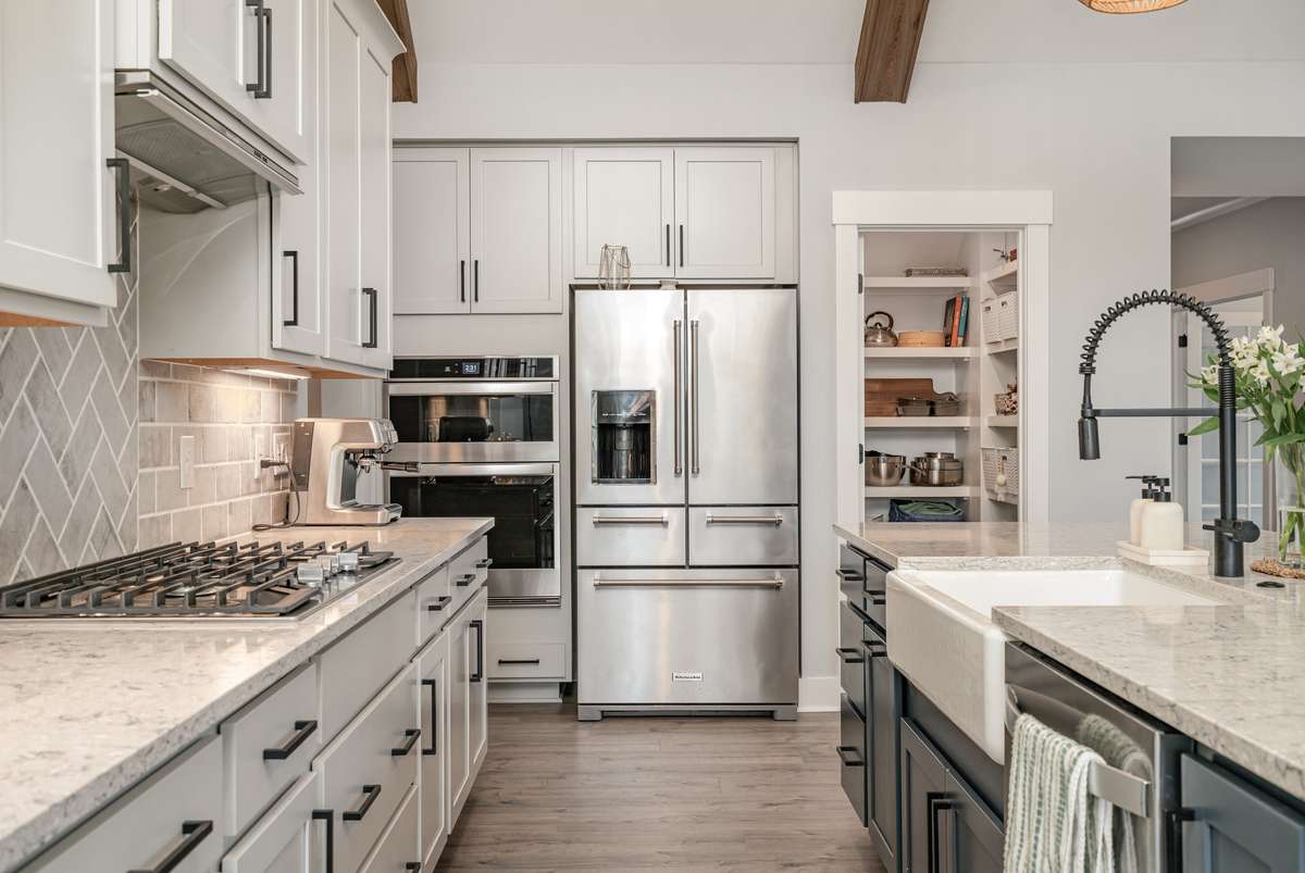 Chef-inspired kitchen featuring upgraded lighting and a seamless flow for entertaining. All appliances included!