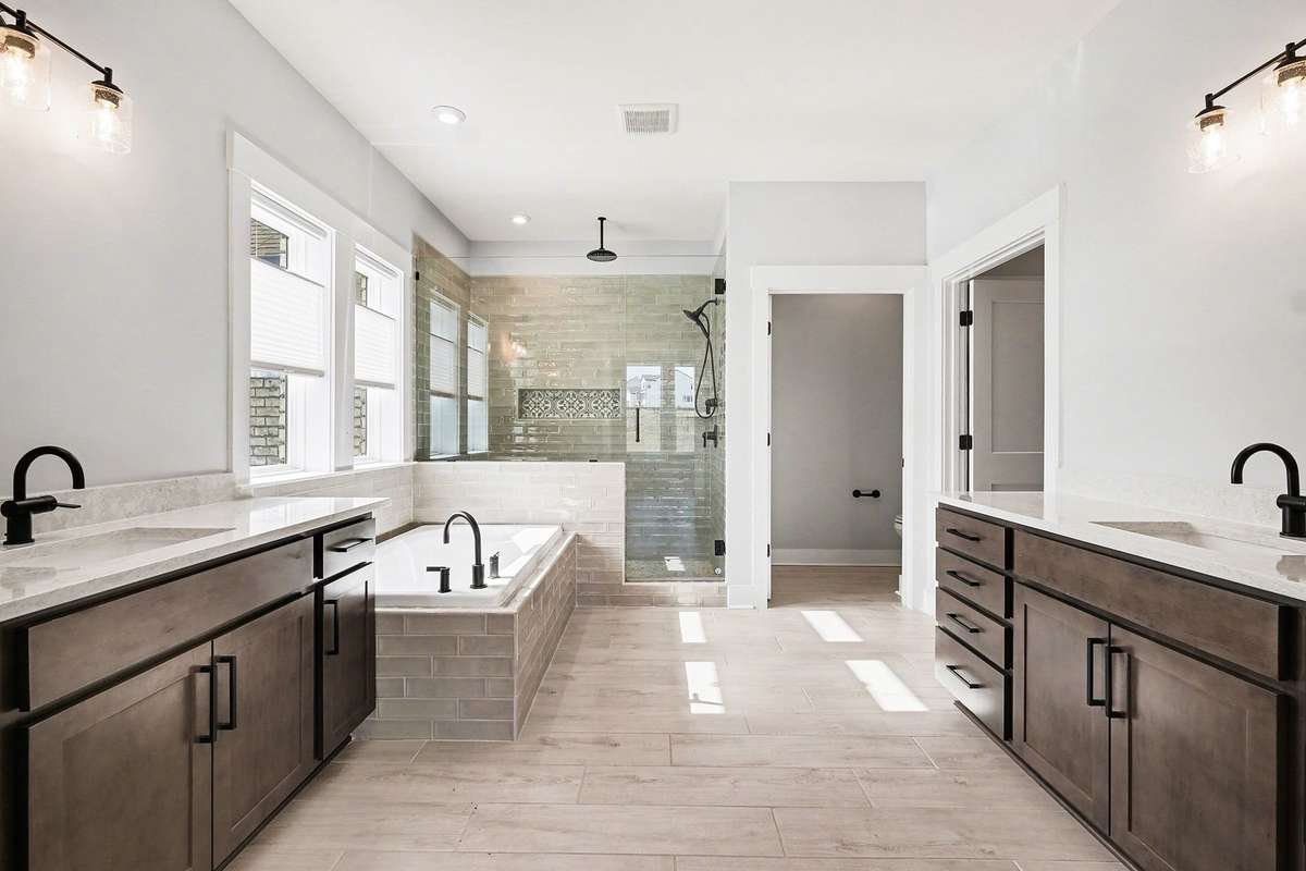 Spa-like primary bath featuring upgraded designer tile and high-end finishes for a resort-style feel.