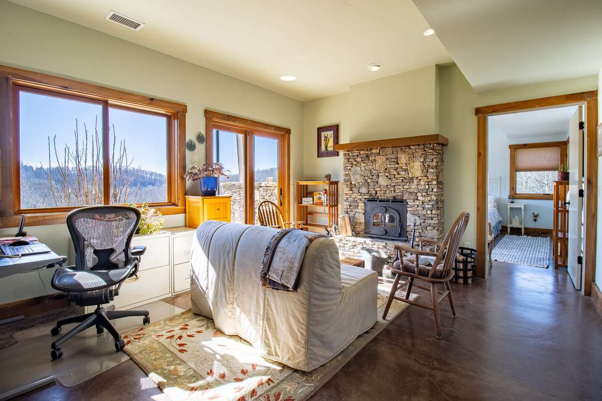 As you come down the stairs, you enter this room with a wood stove