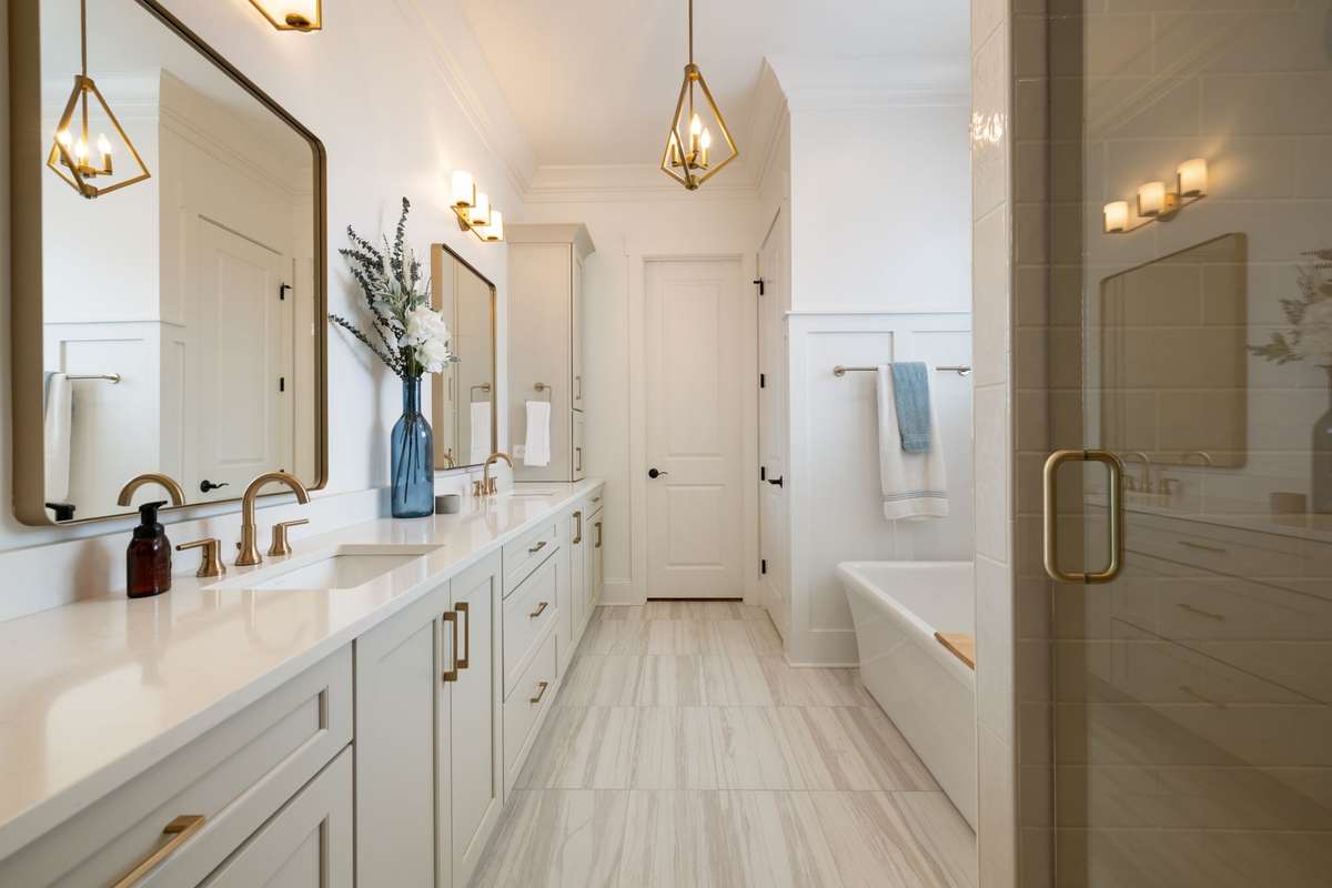 Primary bath with custom tile shower, soaking tub, dual vanities, and toilet closet.