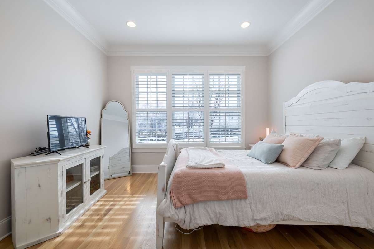 Second bedroom on the main floor has custom walk-in closet and en suite bath.