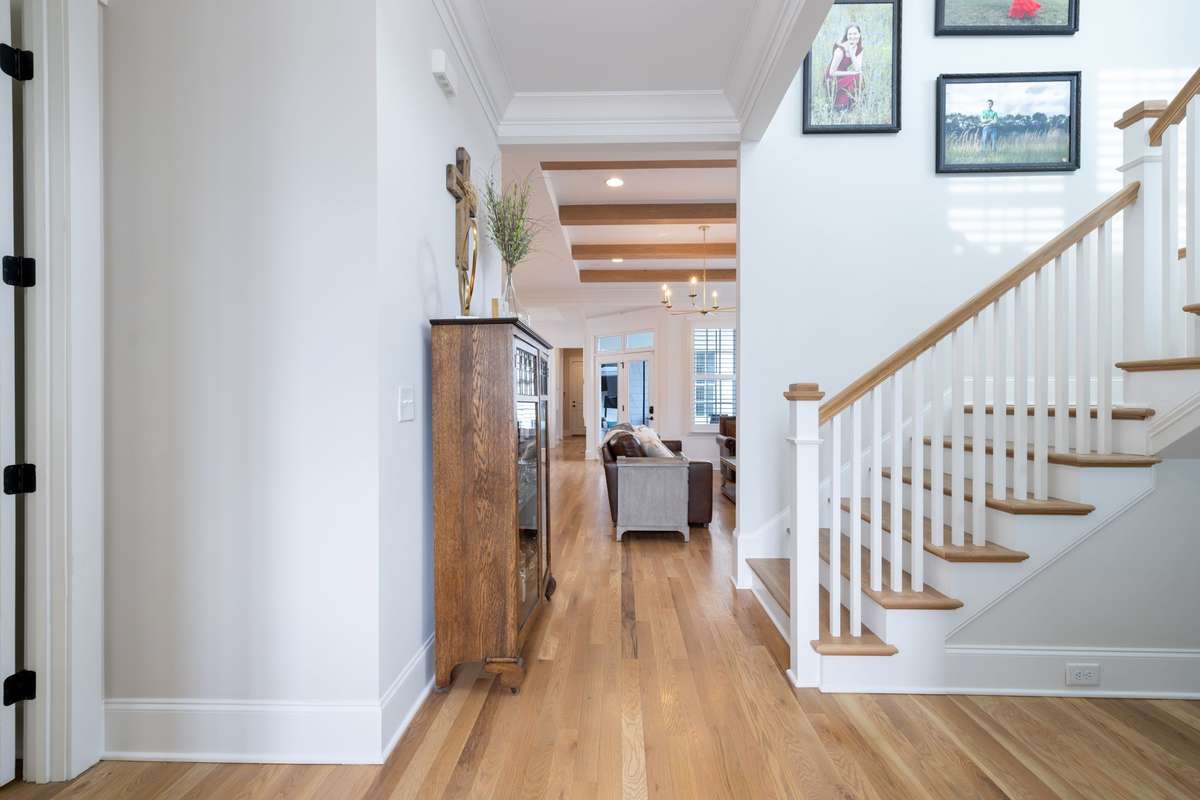 This entry foyer is full of natural light from 2 stories of windows adorning the winding stair case.