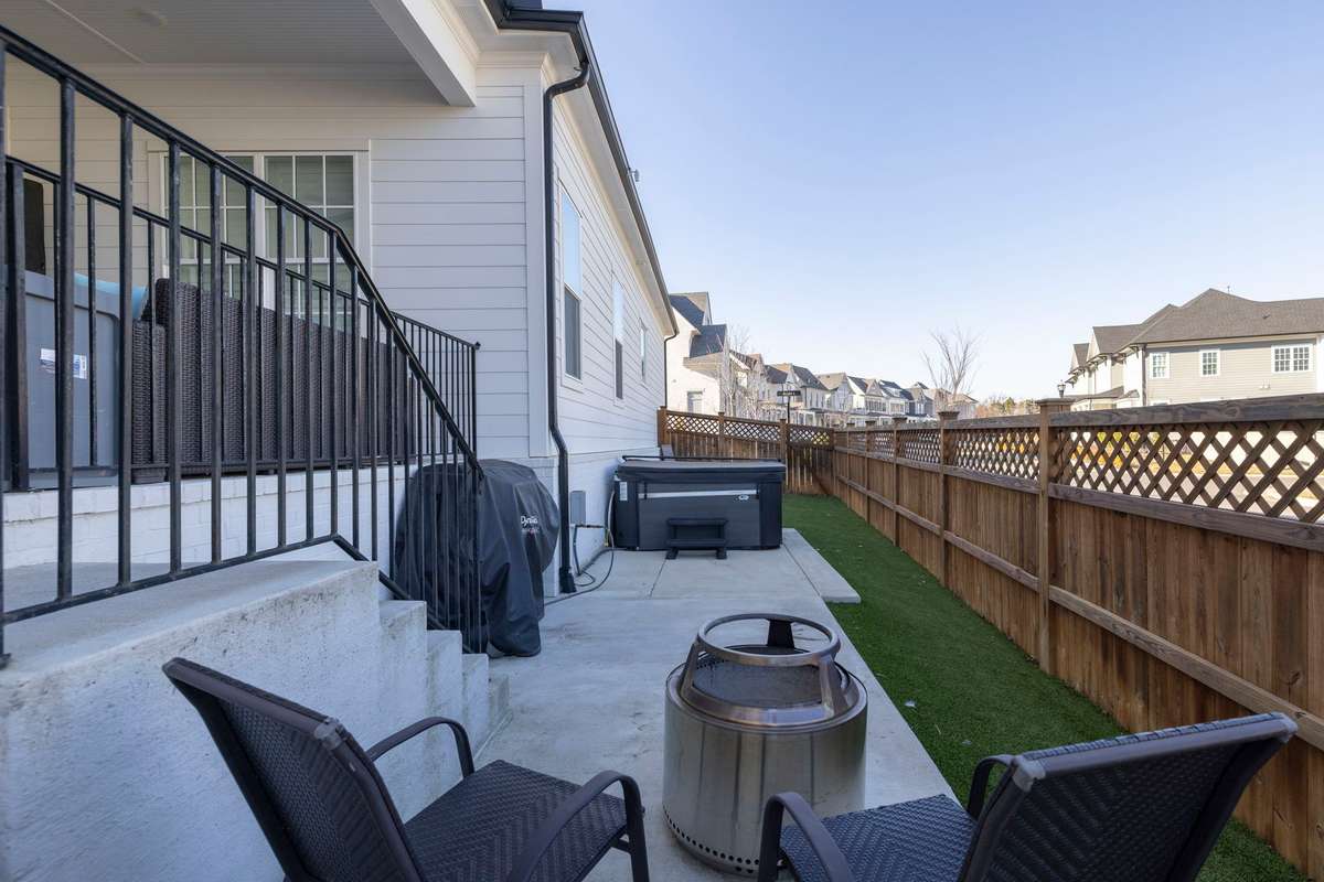 Side yard has turf installed for easy maintenance. Extended patio for hot tub, gas line for grill, and seating area to enjoy.