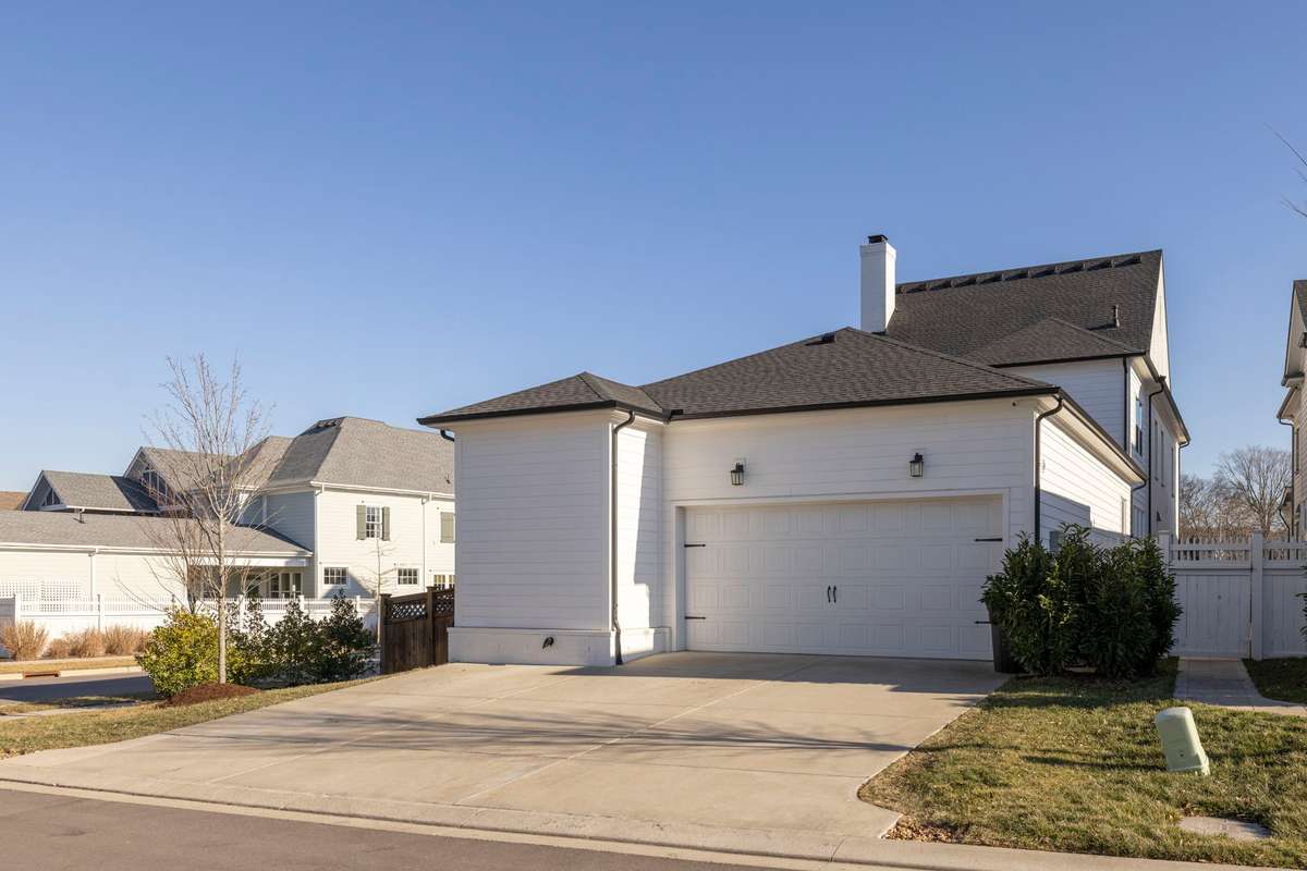 Two car garage, parking spaces for 3 cars in the driveway.