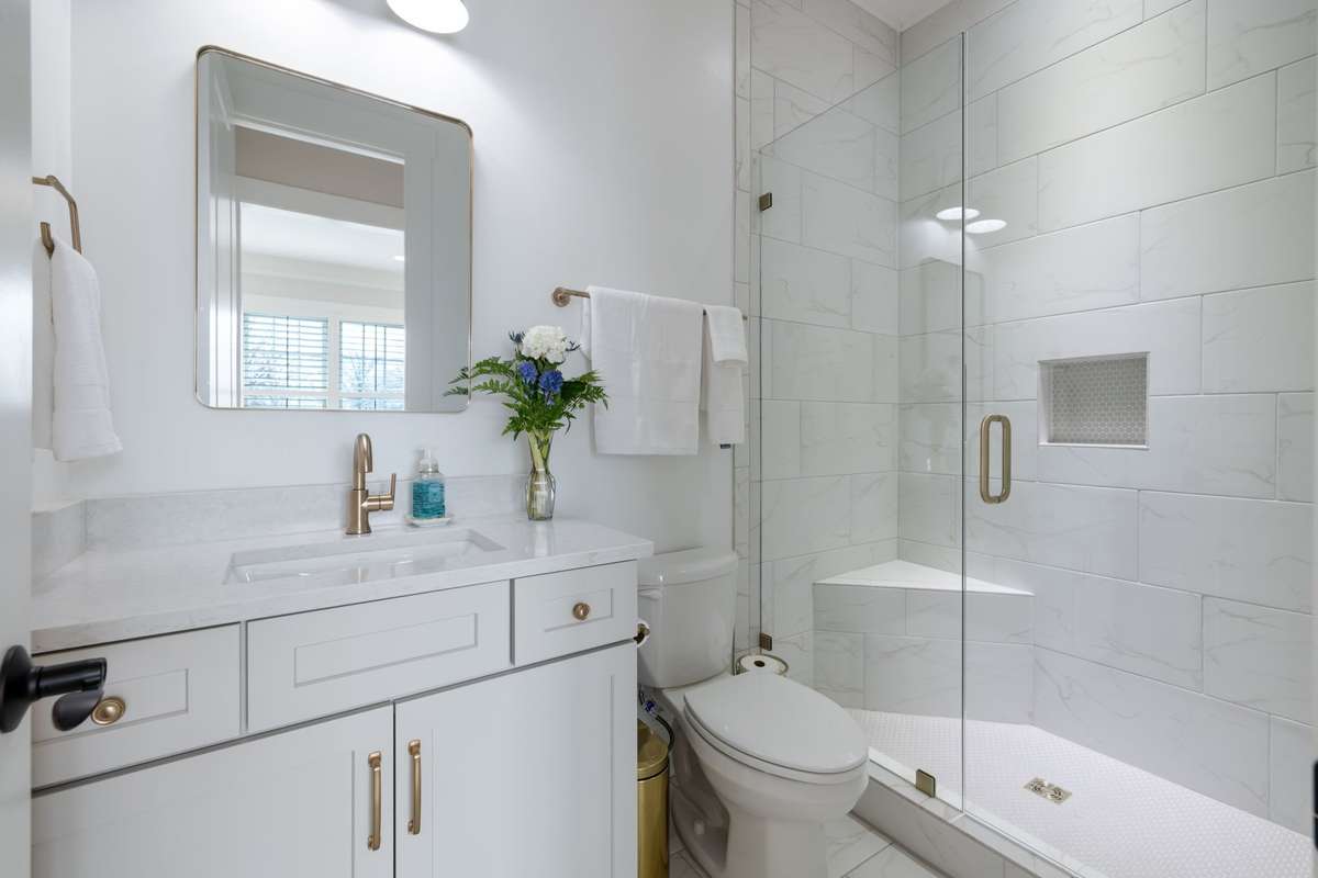 Second full bath on the main floor with custom tile shower.