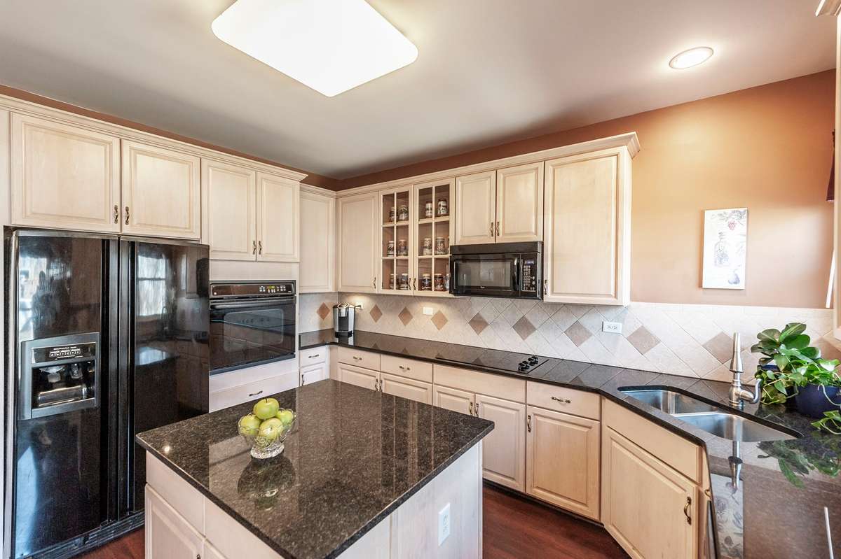 Cabinets trimmed out with crown molding; electrical service in island and abundant countertop space for all your cooking needs.