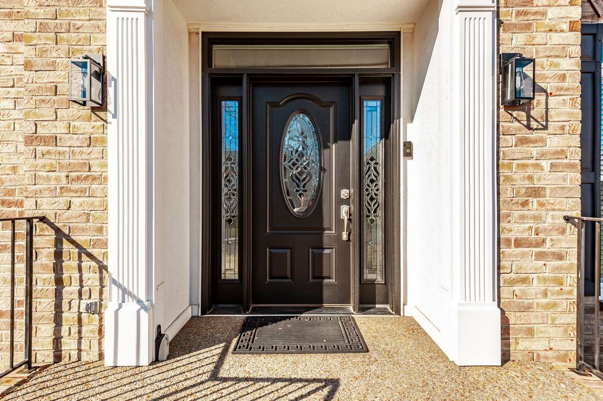 The spacious front porch welcomes you to 102 Fairlake Ct with new front door with lead glass inset, sidelights and transom, allow natural light to fill the entry foyer.