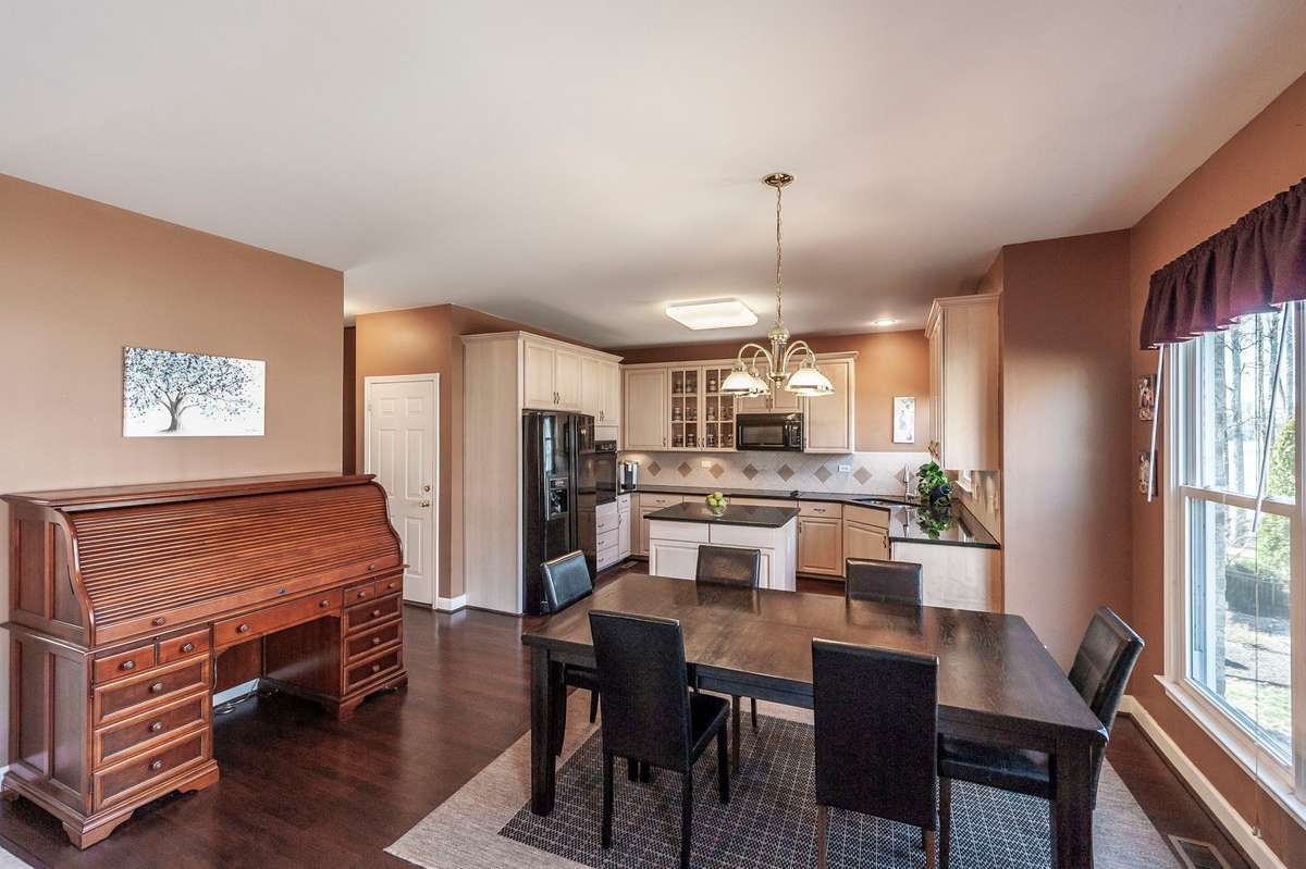 Everyday dining area overlooks the backyard and lake while providing for an enjoyable conversational design during meal prep and dining.