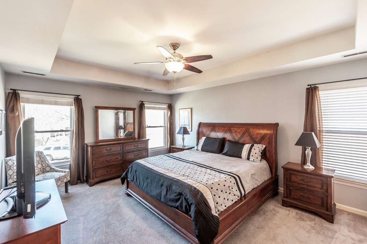 This is a spacious primary suite with trey ceiling, ceiling fan lakeviews and a huge ensuite.
